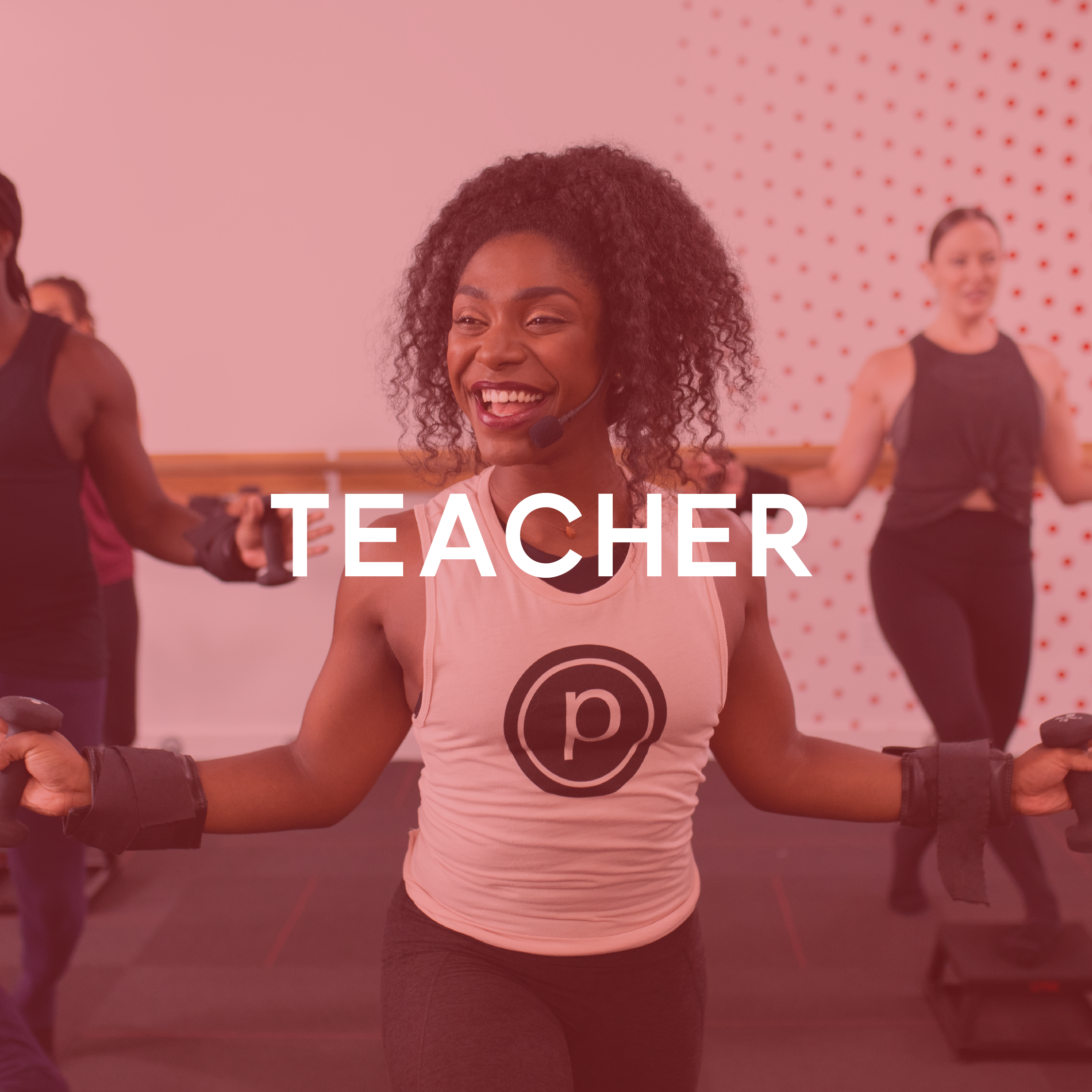 Pure Barre teacher smiling while leading group workout